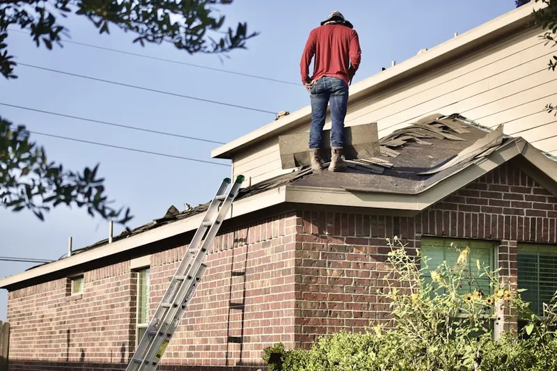 Professional roofer working on a residential roof in Downtown Woburn